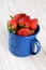 Blue Cup Full of Fresh Picked Ripe Strawberries