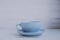 The blue cup and saucer on a light wooden background and the inscription morning love