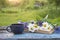 Blue cup of tea and bunch of wild flowers on open book on the old wooden table