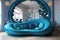 Blue curved round sofa under decorative abstract bubbles or balls arch