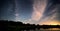 Blue dark night sky with many stars above field of trees. Yellowstone park. Milkyway cosmos background