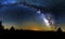 Blue dark night sky with many stars above field of trees. Yellowstone park. Milkyway cosmos background