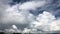 Blue daylight summer sky with fluffy white clouds as nature image. Time lapse shot.