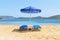 Blue deckchairs under parasol