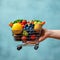 Blue delight Hand holding shopping cart with vibrant fruits and vegetables