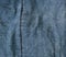 Blue denim close-up and a vertical seam