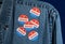 Blue denim working clothing with many Voted stickers on dark background