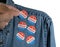 Blue denim working clothing with many Voted stickers on white background