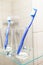Blue dental cleaning brush is in glass in bathroom