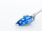 Blue dices in metal spoon on white background