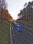 A blue diesel electric commuter train driving on double railway