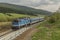 Blue diesel train with passengers coach in Jeseniky mountains