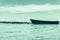 Blue dinghy afloat on peaceful calm Ngunguru estuary Northland N
