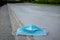 Blue disposable medical mask is on the road surface, on street. to prevent the Virus Covid-19. Concept viruses spread throughout