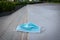 Blue disposable medical mask is on the road surface, on street. to prevent the Virus Covid-19. Concept viruses spread throughout