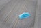 Blue disposable medical mask is on the road surface, on street. to prevent the Virus Covid-19. Concept viruses spread throughout