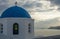 Blue dome of white church and clouds, Oia, Santorini, Greece