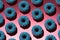 Blue donuts with pink crumb on a pink background
