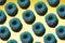 Blue donuts with pink crumb on a yellow background