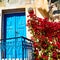 blue door in antique village santorini flower