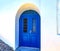 Blue door on whitewashed wall - Santorini island, Greece