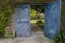 Blue double gates in a country garden