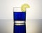 Blue drink in a glass Cup with reflection, a slice of lemon