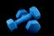 Blue Dumbells on a Black Background