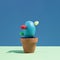 Blue Easter egg arranged like a potted cactus on a green and blue background