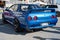 blue eighth-generation Nissan Skyline GT R32 at a Japanese sports car meet.