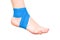 Blue elastic ankle bandage, white background, isolate. The concept of fixing a sore joint on the leg, close-up