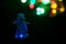 Blue electric snowman night light on black background