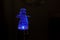 Blue electric snowman night light on black background