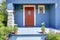 Blue entrance porch with red door.