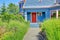 Blue entrance porch with red door.