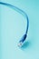 Blue Ethernet Cable Cord Patch cord on a blue background with free space