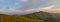 Blue evening sky above grassy mountain ridge