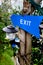 Blue exit sign on tree