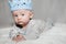 Blue Eyed Baby Wearing Blue Knit Crown