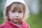 Blue-eyed little child caucasian girl face closeup