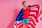 Blue eyes blonde charming female kid celebration independence holding a paper torch and diy crown and american flag on a