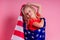 Blue eyes blonde charming female kid celebration independence holding a paper torch and diy crown and american flag on a