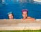 Blue eyes children girls on on blue pool poolside smiling