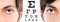 blue eyes close up on visual test chart, eyesight and eye examination concept in white background