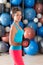 Blue eyes girl at gym weightlifting dumbbells