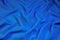 Blue fabric abstract background for design and creativity. Folds of fabric form a natural unique creative, abstract pattern,