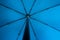 Blue fabric open umbrella mechanism inside point of view concept