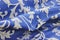 Blue fabric with white embossed design background - selective focu