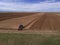 Blue Farm Tractor Plowing Large Farm Field