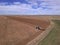 Blue Farm Tractor Plowing Large Farm Field